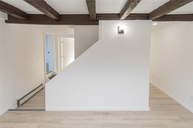 basement with a baseboard radiator and light wood-type flooring