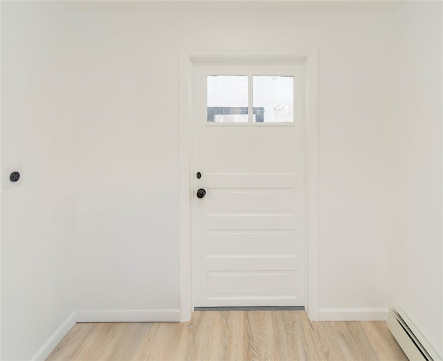 doorway to outside featuring a baseboard radiator and light hardwood / wood-style floors