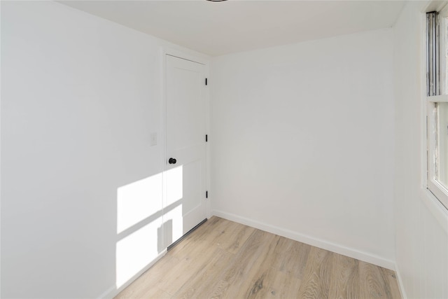 clothes washing area featuring light wood-type flooring