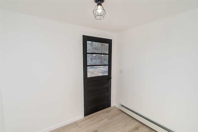 doorway to outside with a baseboard radiator and light hardwood / wood-style floors