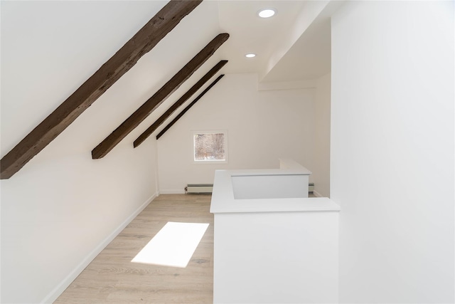 additional living space with lofted ceiling with beams, light hardwood / wood-style flooring, and a baseboard heating unit