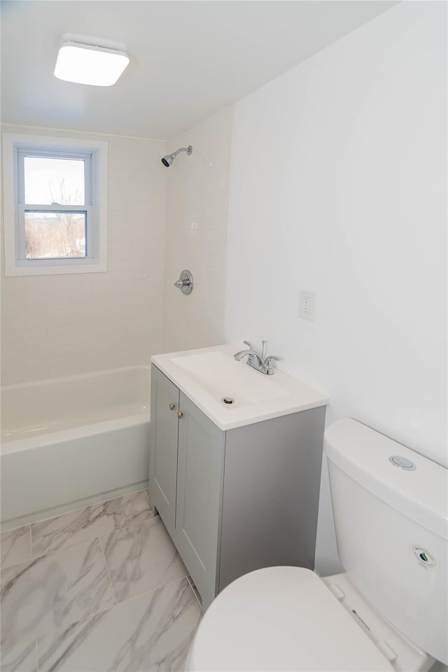 full bathroom with vanity, tiled shower / bath combo, and toilet