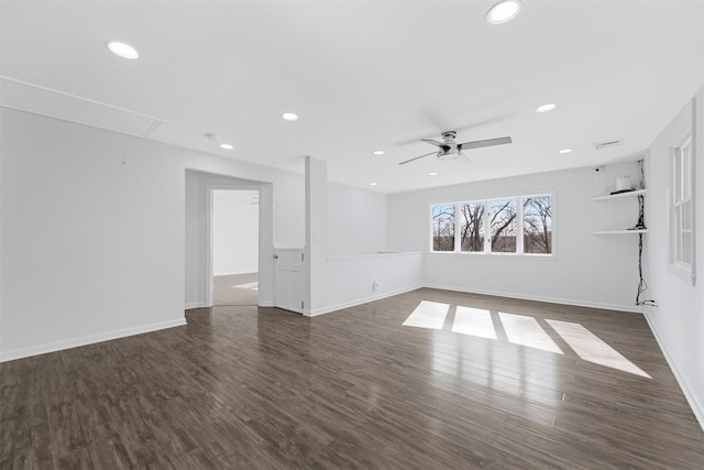 empty room with ceiling fan and dark hardwood / wood-style flooring