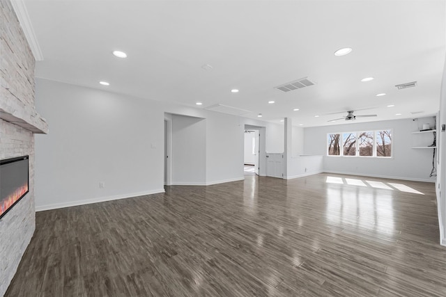 unfurnished living room featuring ceiling fan, dark hardwood / wood-style floors, and a fireplace