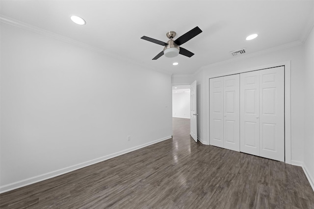 unfurnished bedroom featuring crown molding, ceiling fan, dark hardwood / wood-style flooring, and a closet