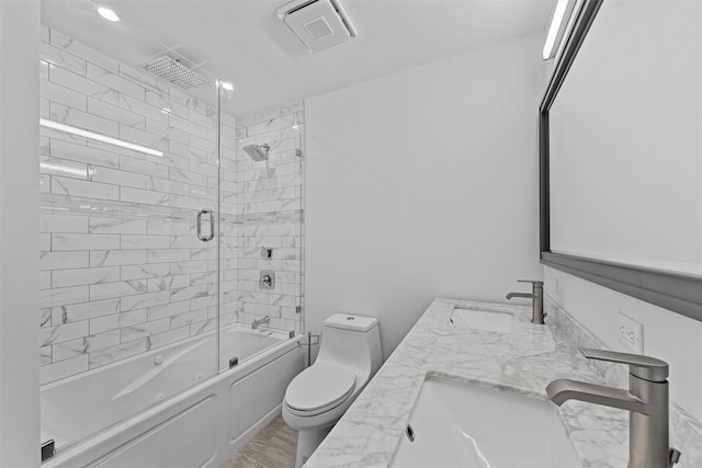 full bathroom with vanity, toilet, and combined bath / shower with glass door