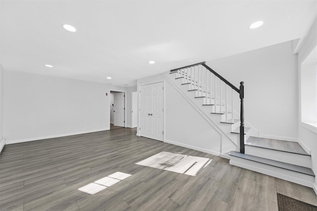 unfurnished living room featuring dark wood-type flooring