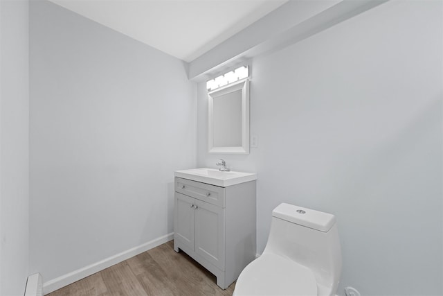 bathroom with vanity, hardwood / wood-style flooring, and toilet