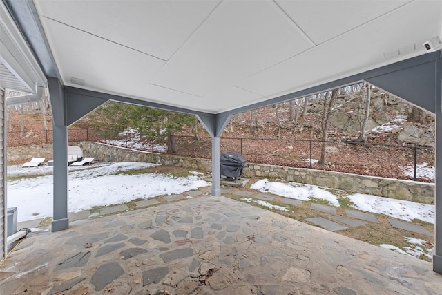 snow covered patio with area for grilling