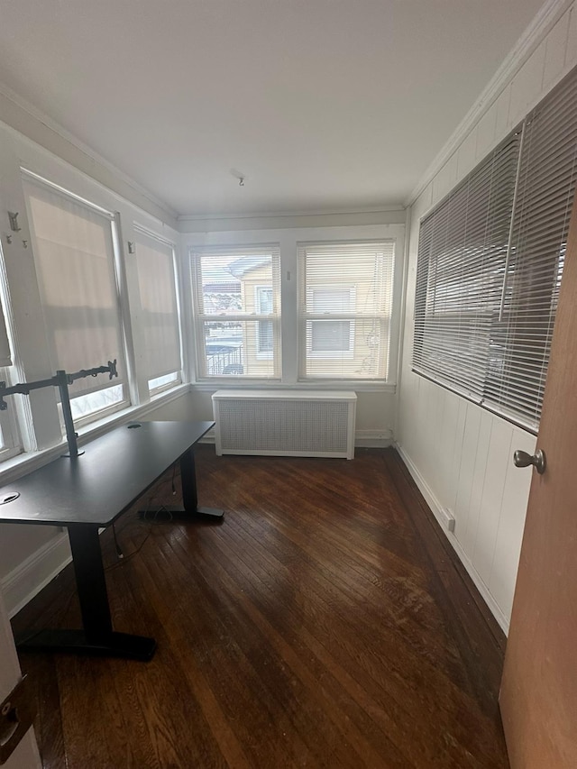 interior space with dark wood-type flooring, radiator heating unit, and ornamental molding