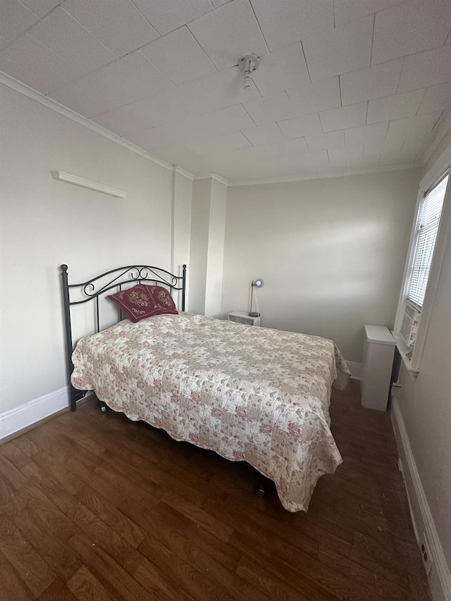 bedroom with cooling unit, crown molding, and dark hardwood / wood-style floors