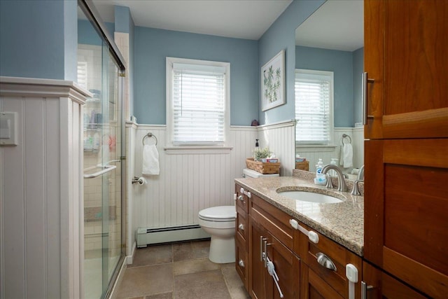 bathroom with vanity, a baseboard heating unit, toilet, and walk in shower