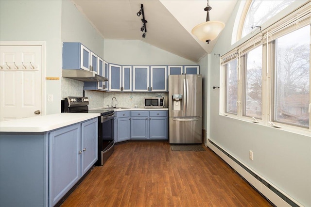 kitchen with pendant lighting, lofted ceiling, baseboard heating, stainless steel appliances, and blue cabinetry