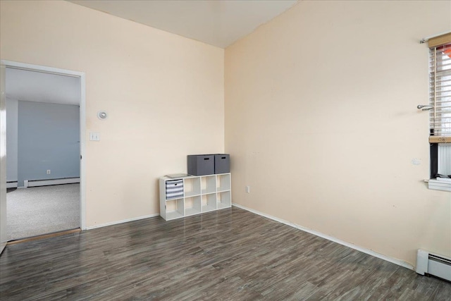 empty room with dark hardwood / wood-style flooring and a baseboard radiator