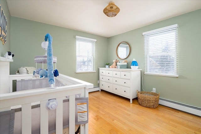 bedroom featuring a baseboard radiator and wood-type flooring