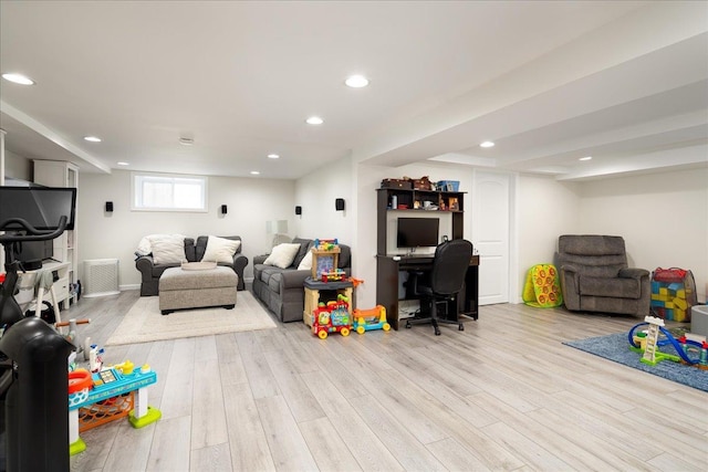 rec room with light hardwood / wood-style flooring