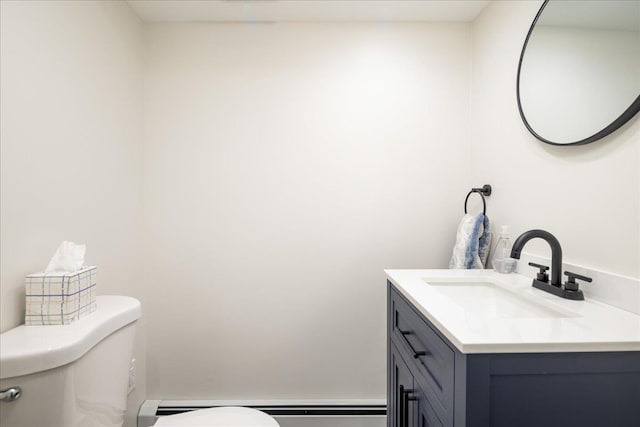 bathroom with vanity, toilet, and a baseboard heating unit