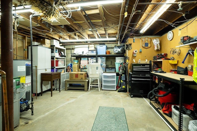 basement featuring water heater and a workshop area