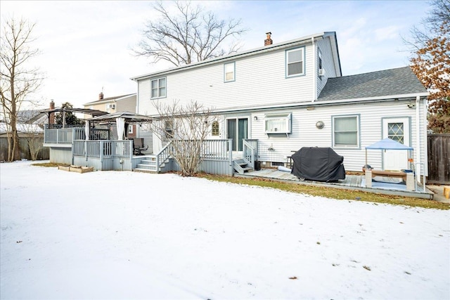 snow covered property with a gazebo and a wooden deck