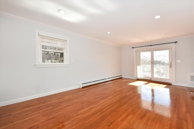 unfurnished room with a baseboard radiator, ornamental molding, and hardwood / wood-style floors