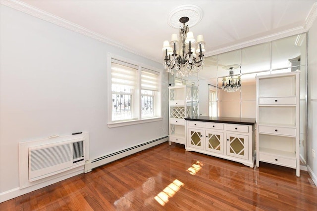 dining room featuring hardwood / wood-style flooring, a baseboard radiator, a wall mounted AC, and a chandelier