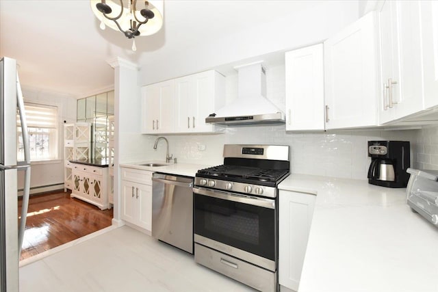 kitchen with white cabinetry, wall chimney range hood, and appliances with stainless steel finishes