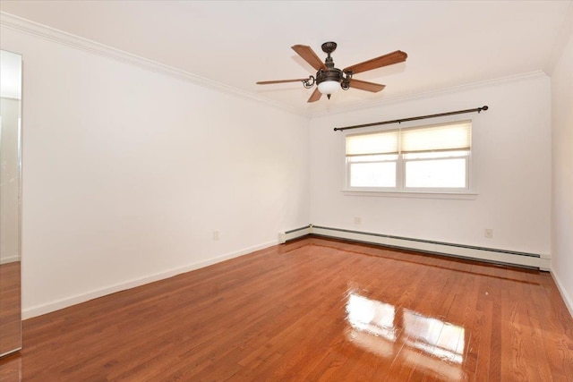 spare room featuring baseboard heating, ceiling fan, ornamental molding, and hardwood / wood-style flooring