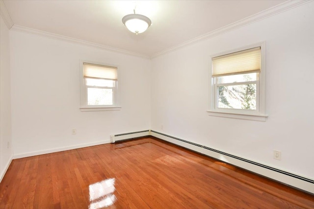 unfurnished room featuring hardwood / wood-style floors, crown molding, and a baseboard heating unit