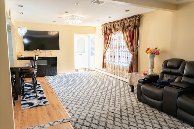 living room with wood-type flooring and a notable chandelier