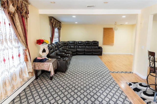 living room with hardwood / wood-style floors and a baseboard heating unit