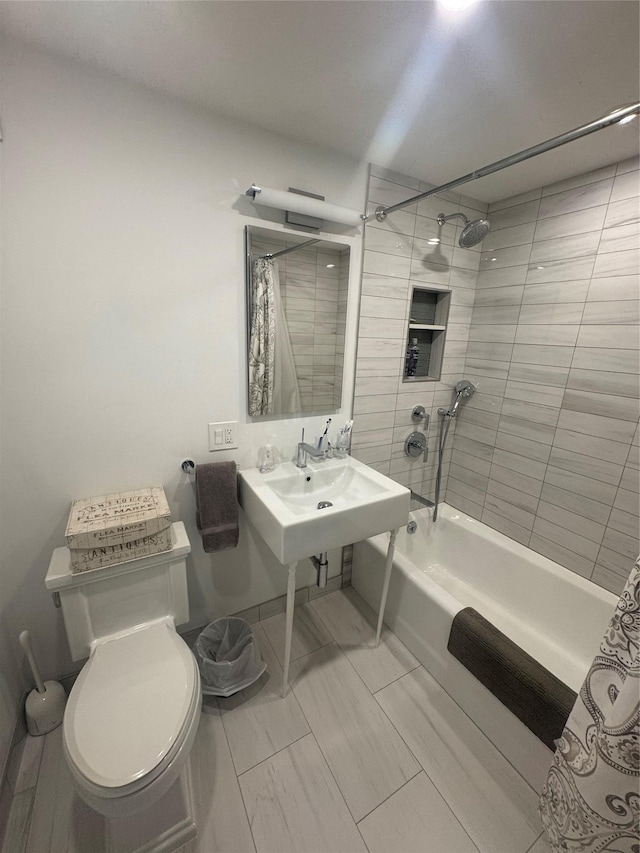 full bathroom with sink, shower / tub combo with curtain, and toilet