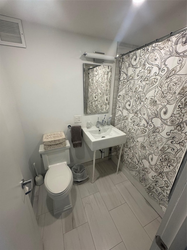 bathroom featuring sink and toilet