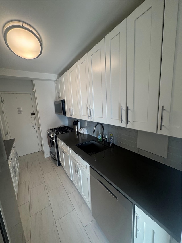 kitchen featuring sink, white cabinets, and appliances with stainless steel finishes