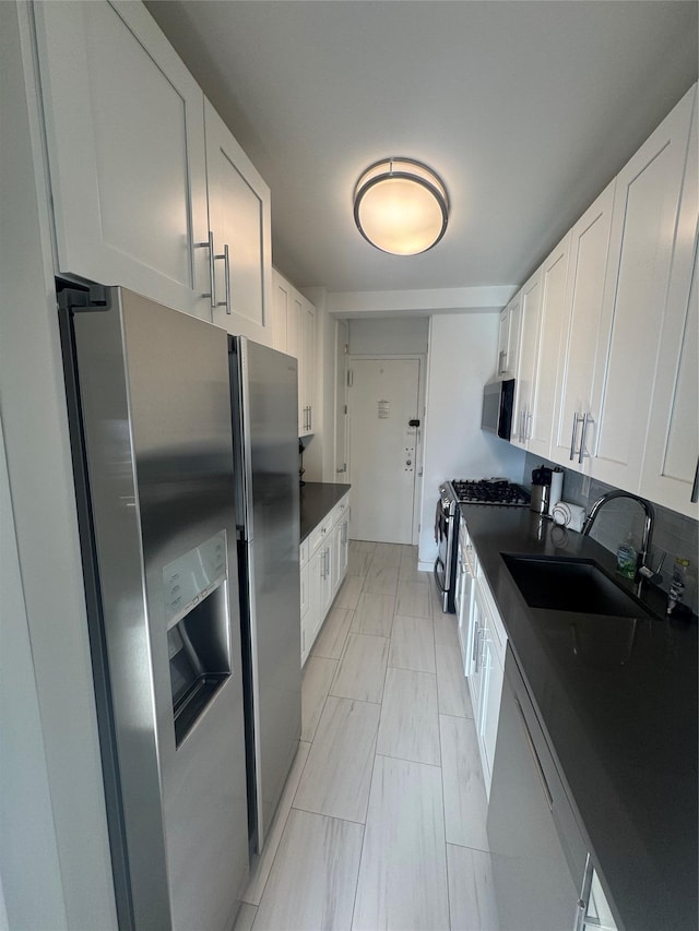 kitchen featuring white cabinetry, stainless steel appliances, and sink