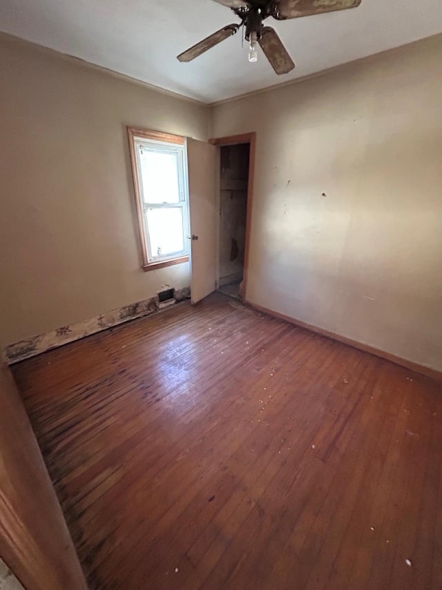 empty room featuring ceiling fan and hardwood / wood-style floors