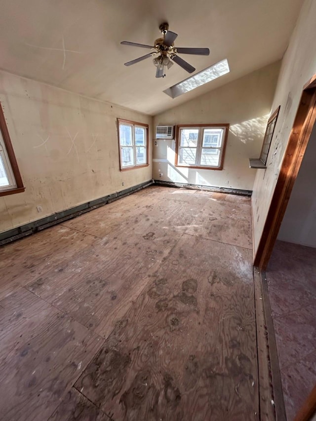 spare room with lofted ceiling with skylight, an AC wall unit, and ceiling fan