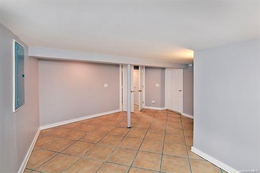 basement with light tile patterned flooring