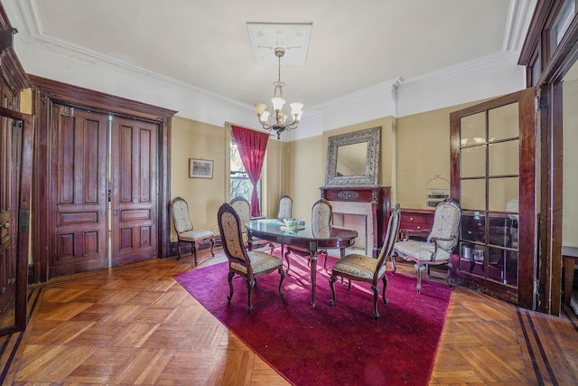 dining room with parquet floors, crown molding, and an inviting chandelier