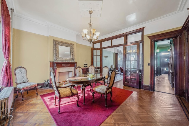 dining area featuring radiator, crown molding, parquet flooring, and a chandelier