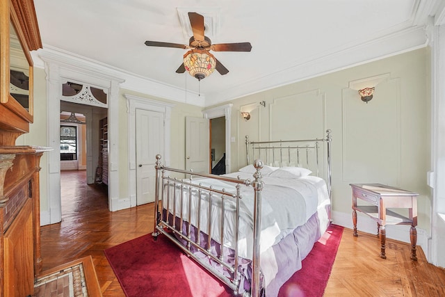 bedroom with parquet floors, ceiling fan, and crown molding