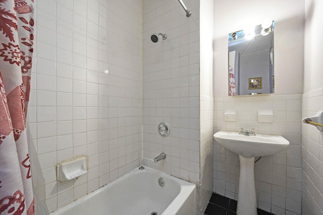 bathroom featuring tile walls and shower / bath combination with curtain