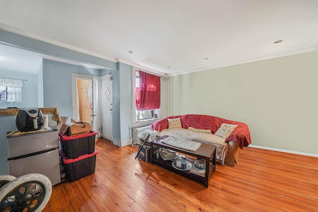 bedroom with multiple windows, ornamental molding, and hardwood / wood-style floors