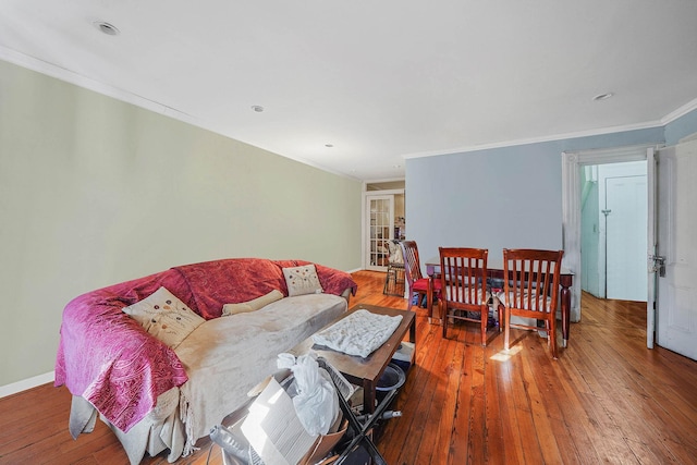 living room featuring ornamental molding and wood-type flooring