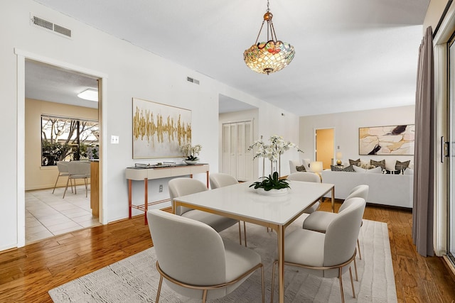 dining space with hardwood / wood-style flooring