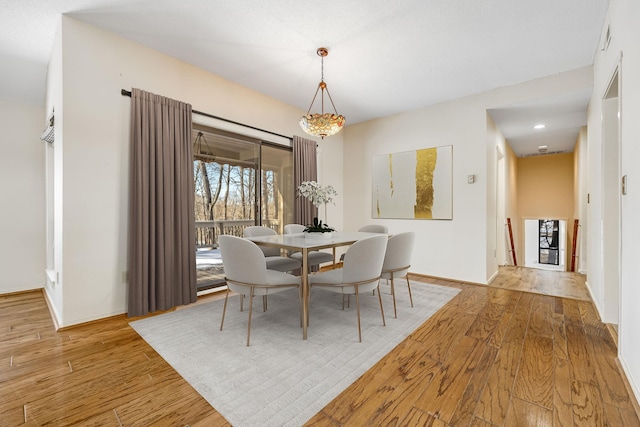 dining space featuring light wood-type flooring