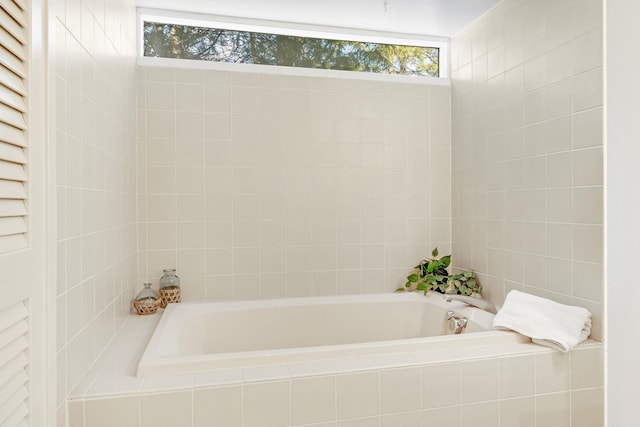 bathroom with tiled tub