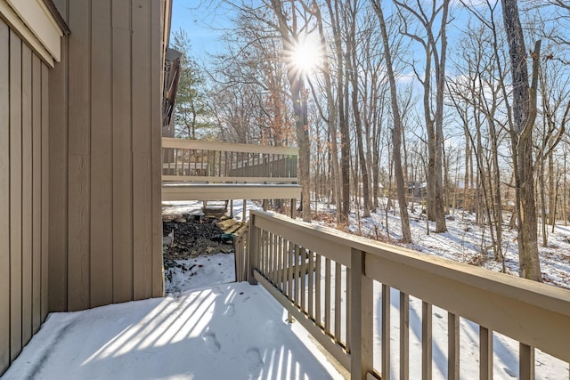 view of snow covered back of property