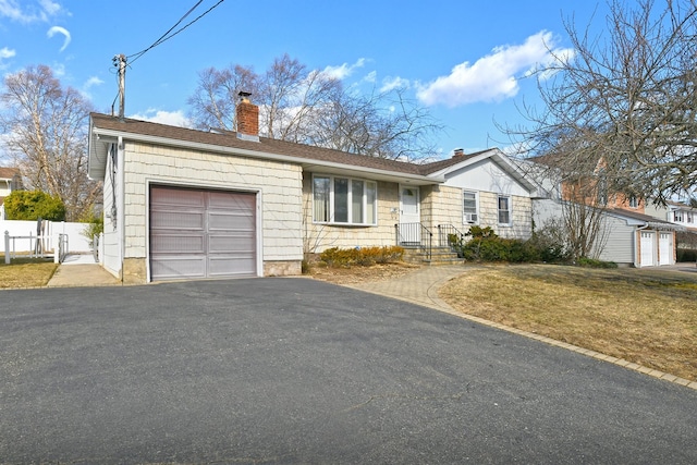 ranch-style house with a garage and a front yard