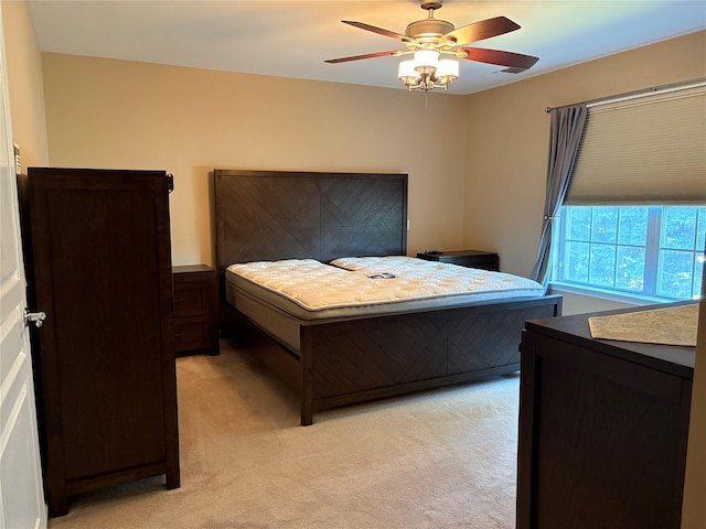 bedroom featuring light colored carpet and ceiling fan