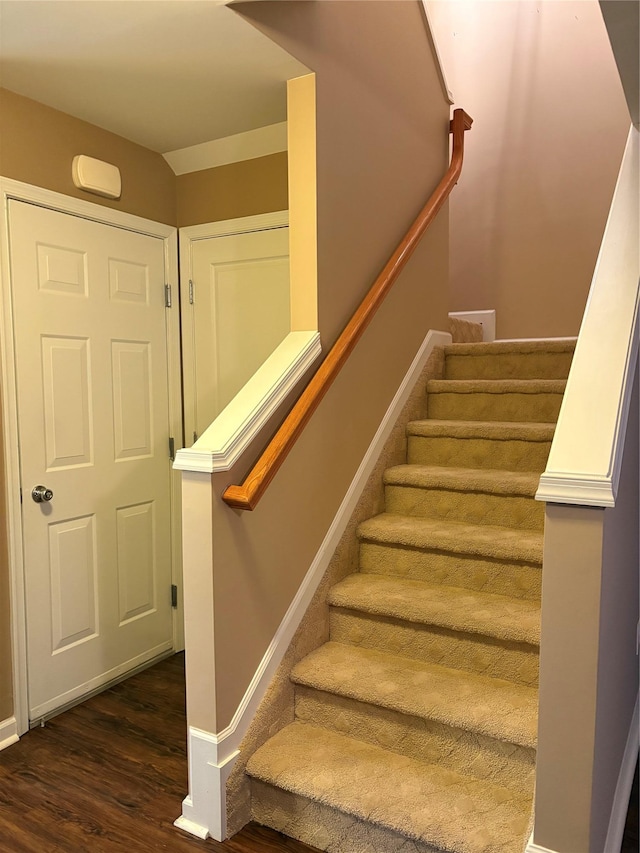 staircase with hardwood / wood-style floors